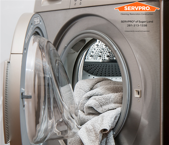Washing machine with towels and Servpro SL logo